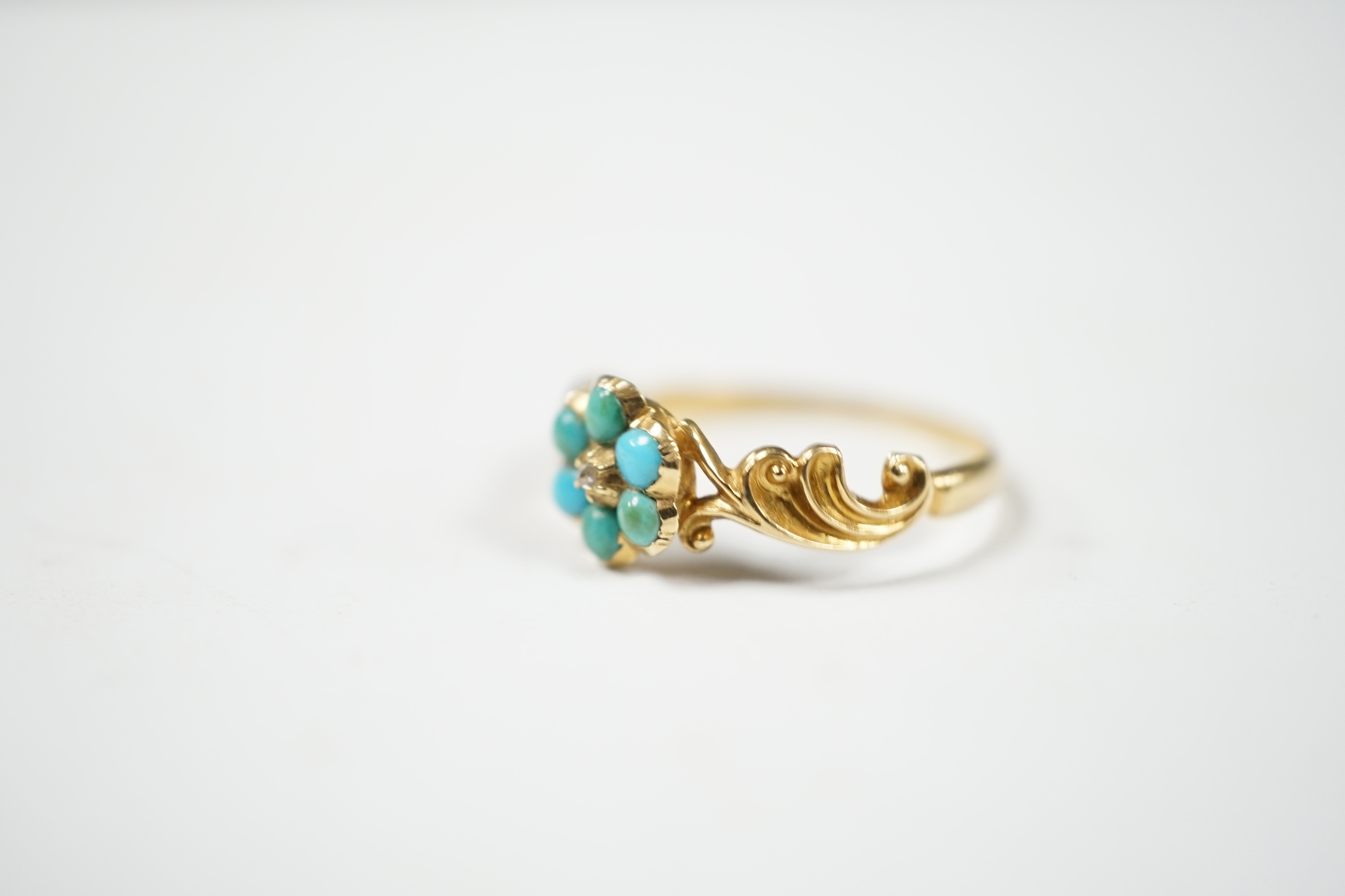 A late Victorian yellow metal, turquoise and rose cut diamond set flower head cluster ring, size L, gross weight 1.4 grams. Condition - fair, band mis-shapen